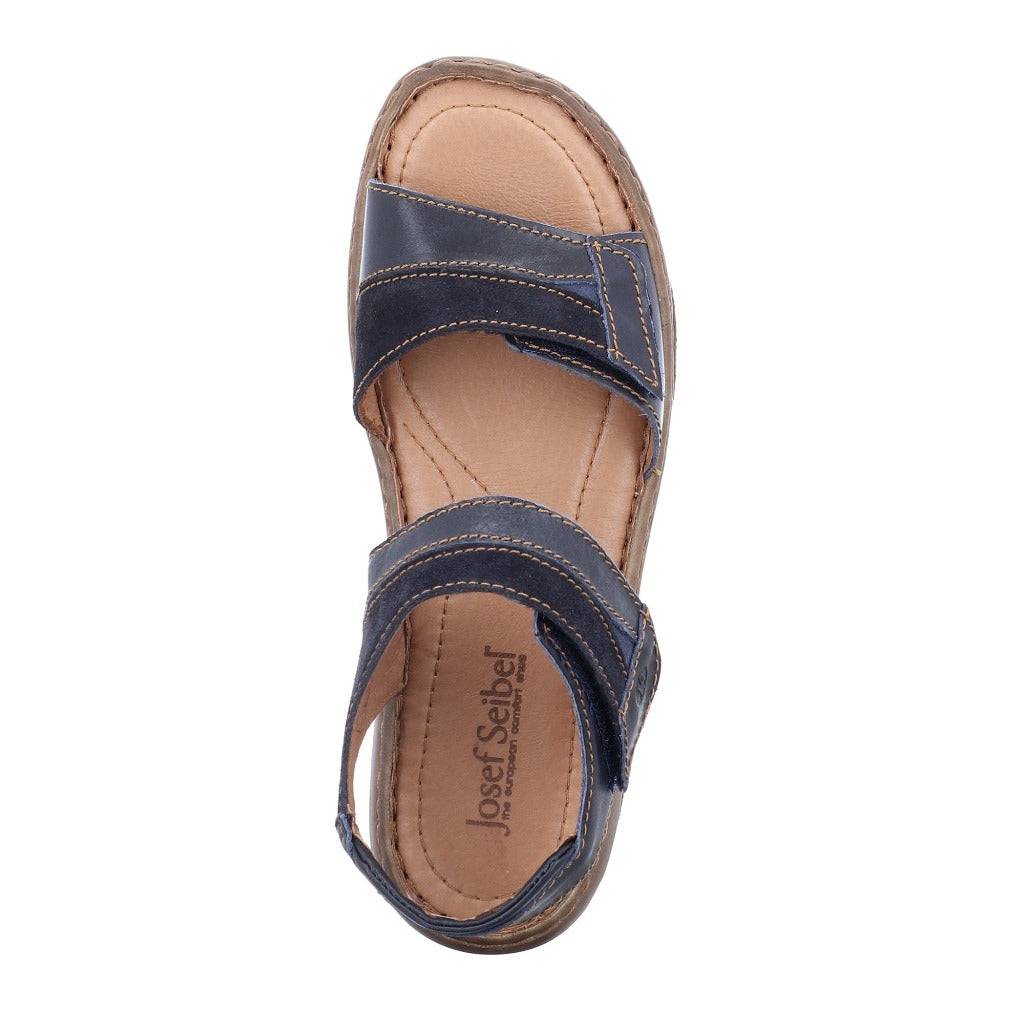 Women's leather adjustable sandal with dark blue cross-strap upper and padded tan footbed