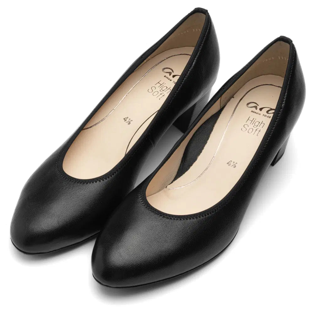 Pair of black leather court shoes with beige insoles and rounded toes.