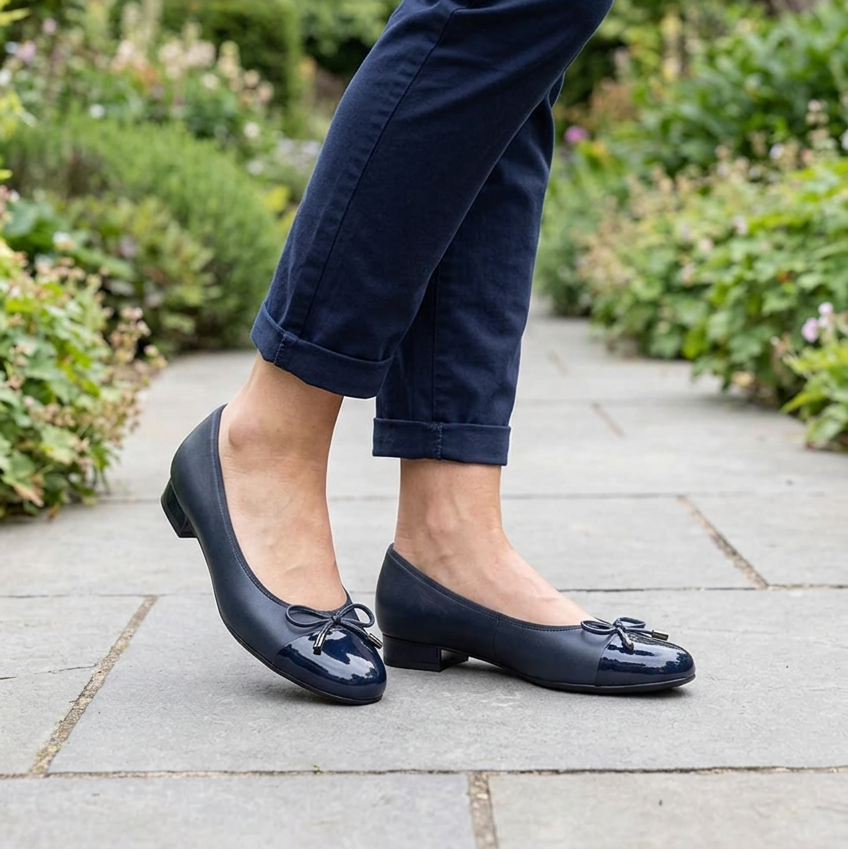 Ara Bari blue ballet flats worn with cropped trousers, showing low heels and bow trim