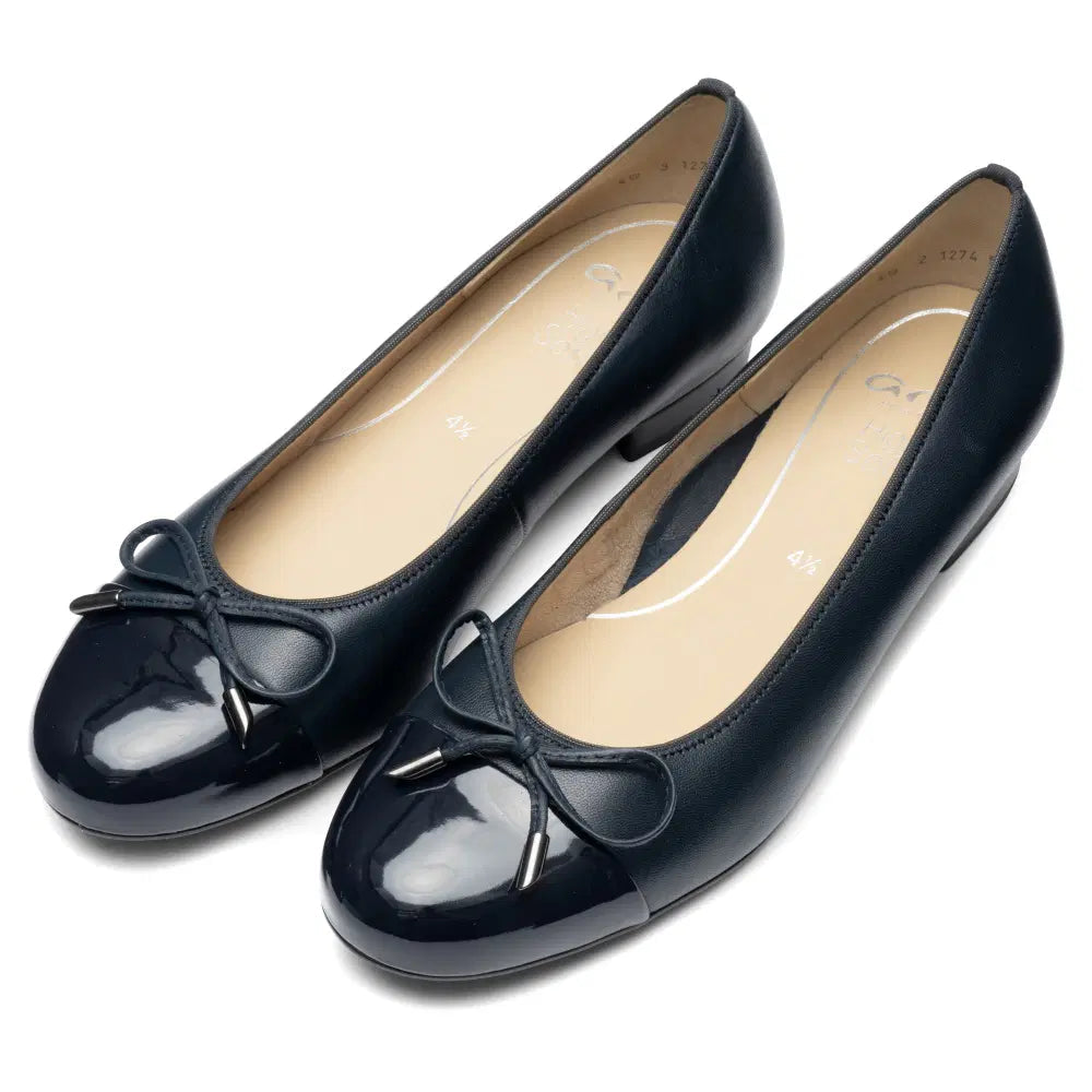 Pair of Ara Bari blue ballet flats with glossy toe caps, bows, and tan insoles