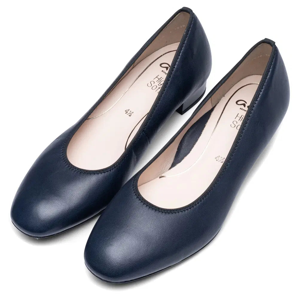 Pair of dark blue leather court shoes viewed from above, with rounded toes