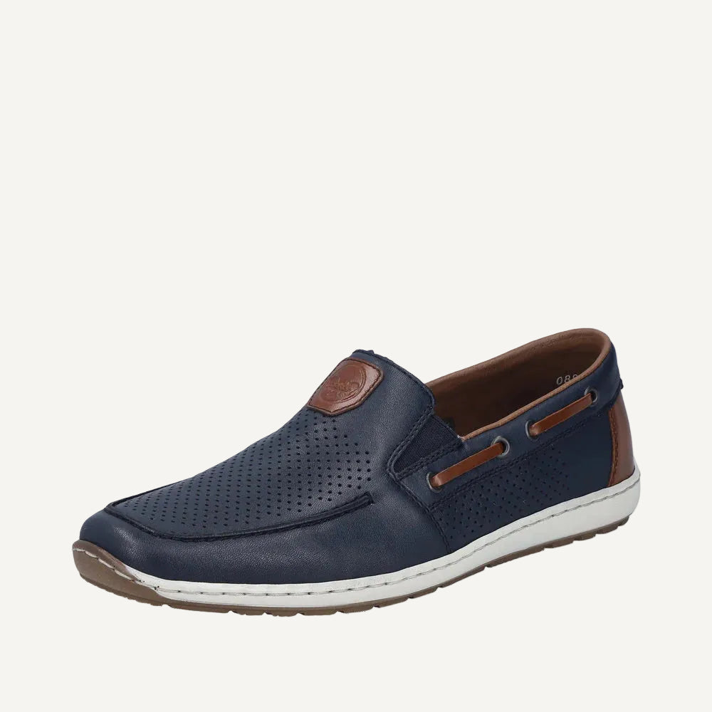 Navy blue slip-on shoe with brown accents on a white background