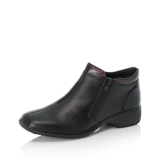 Women’s black leather ankle boot with side zipper and low wedge sole
