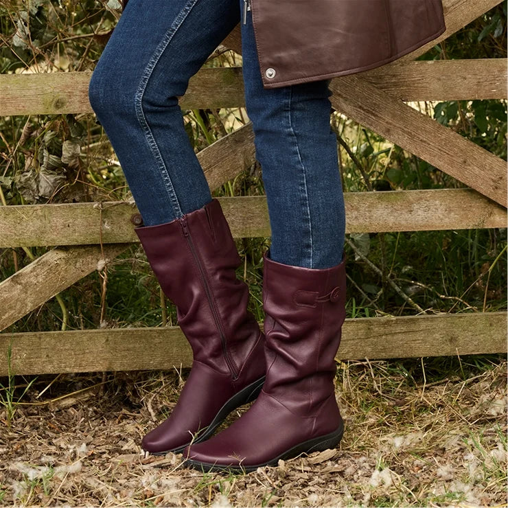 Women’s wide-fit leather boot in dark cherry with buckle strap and flat rubber sole.