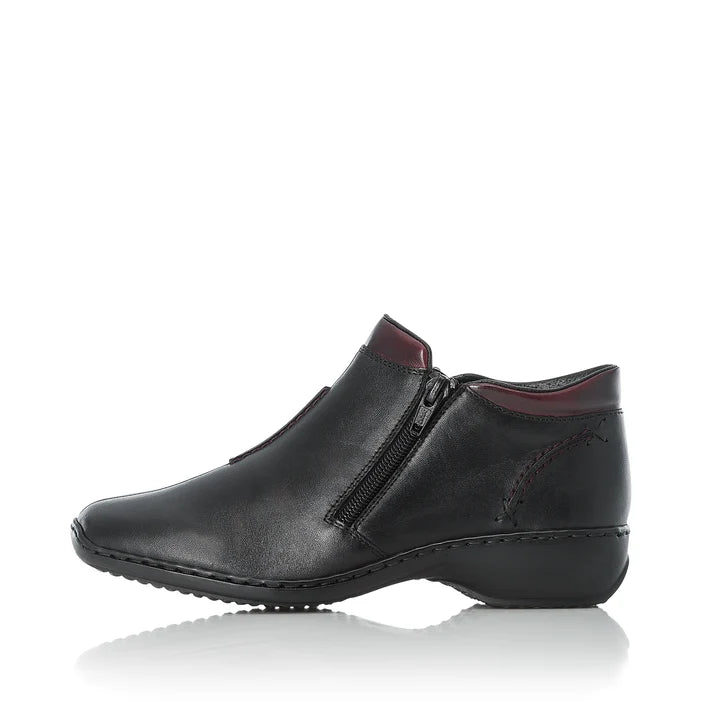Women’s black leather ankle boot side profile with center zipper and stitched trim