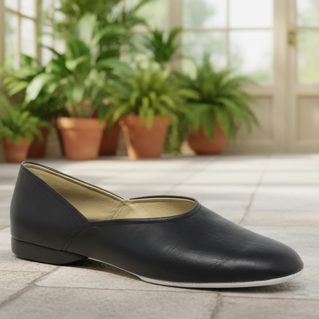 Black slip-on flats with rounded toe and tan interior