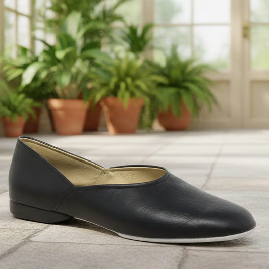 Black slip-on flats with rounded toe and tan interior