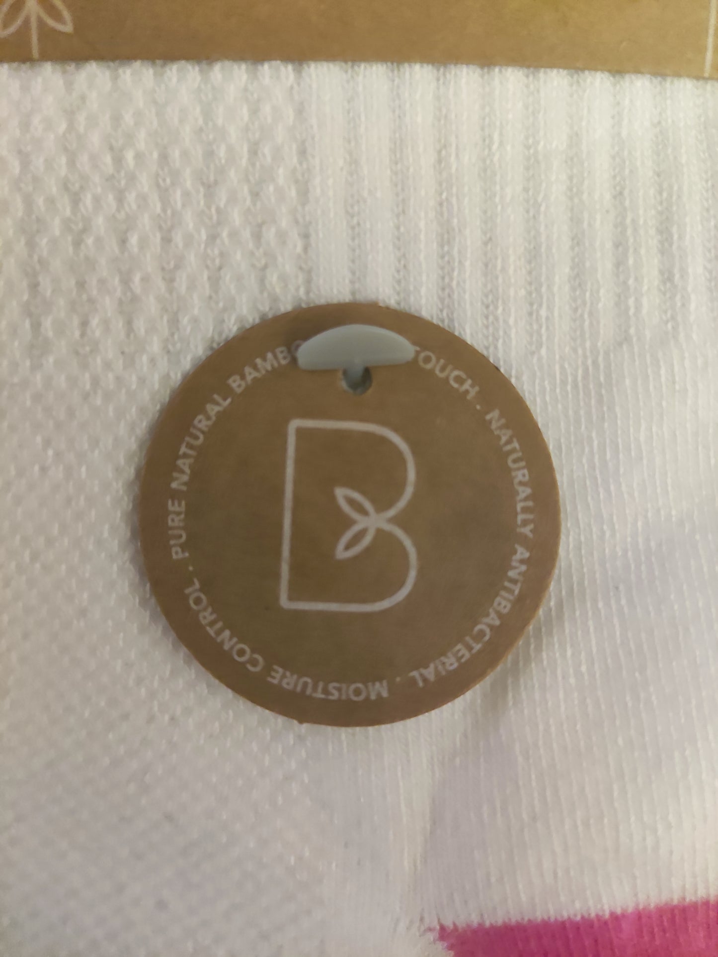 Round brown label on a textured white fabric background