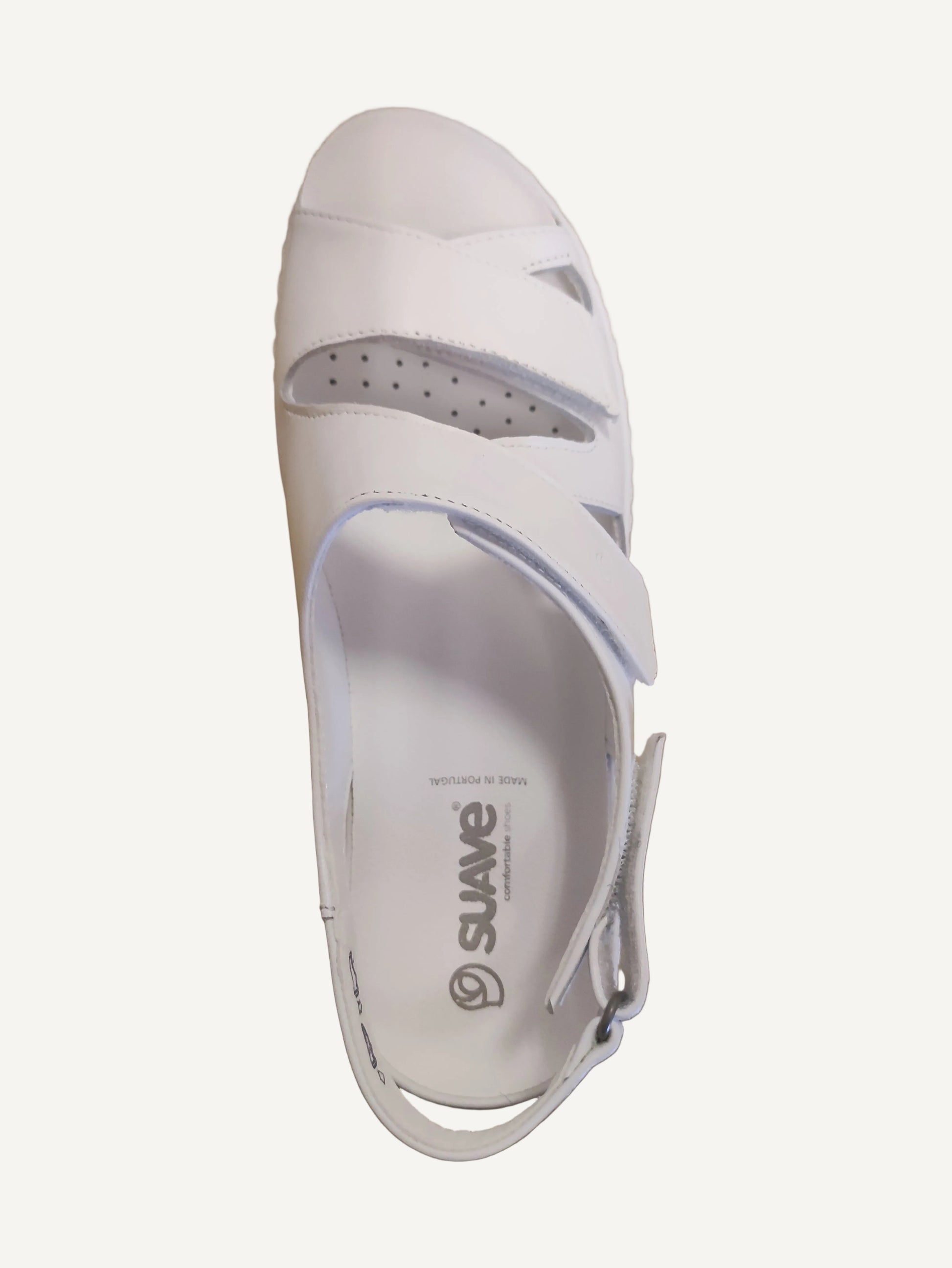 White sandal with gray accents on a wooden surface