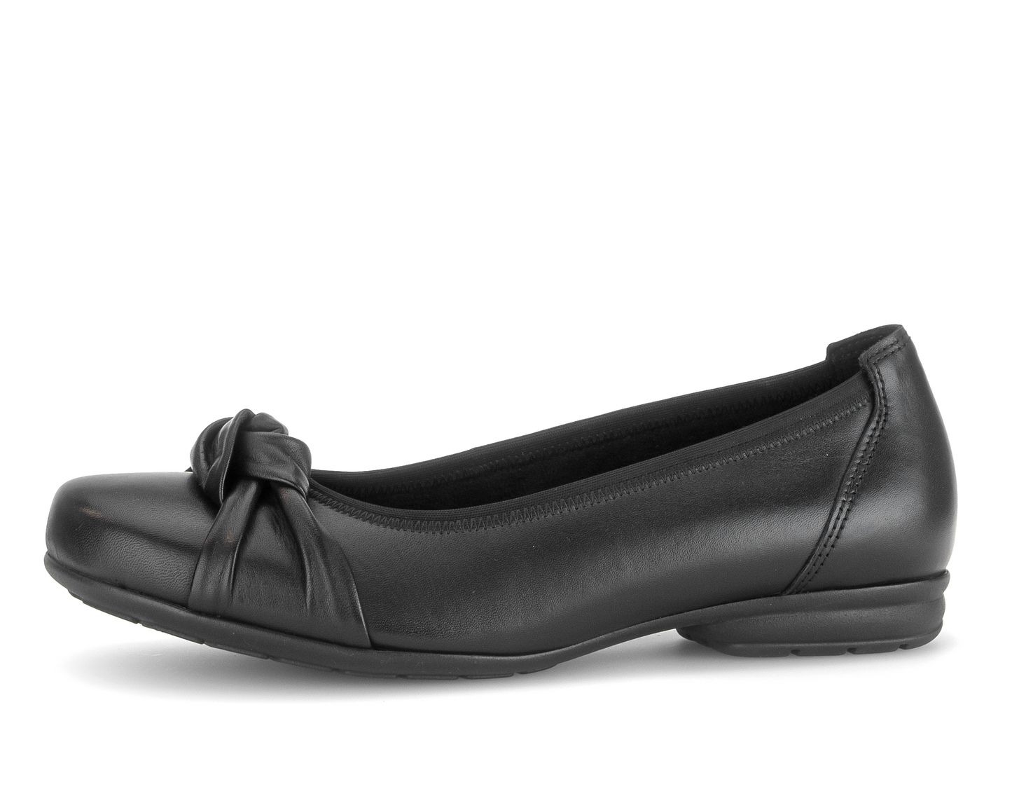 A single black leather flat shoe with a decorative bow detail on the vamp, shown in profile against a plain white background.