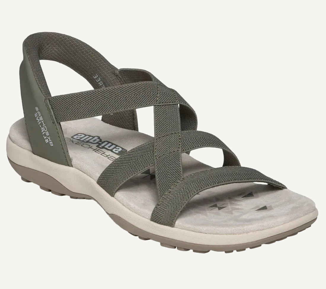 Gray sandal with crisscross straps on a white background
