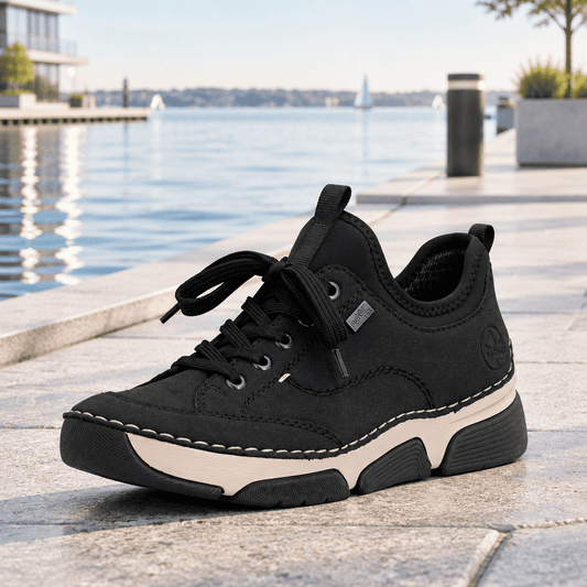Black suede lace-up sneaker with laces and white midsole, side profile