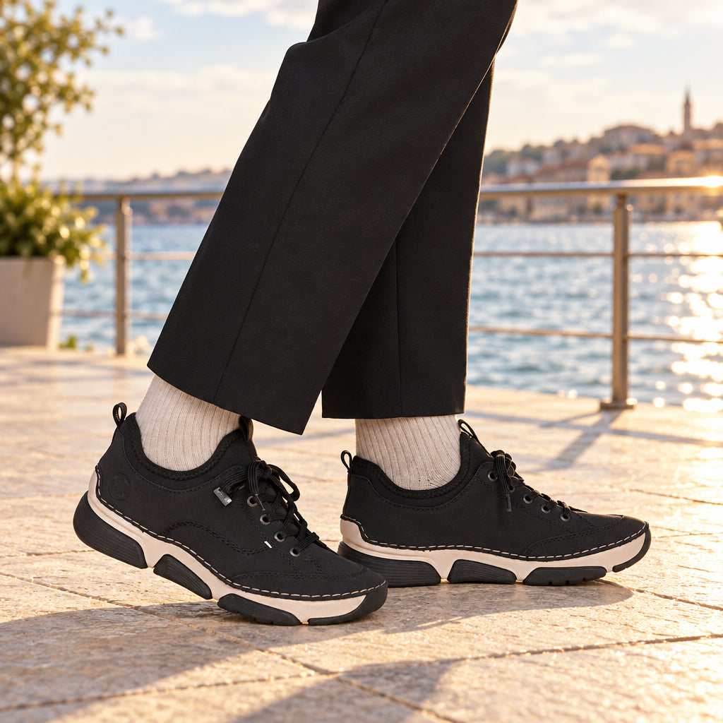 Black suede lace-up sneakers with white midsole and visible outsole tread