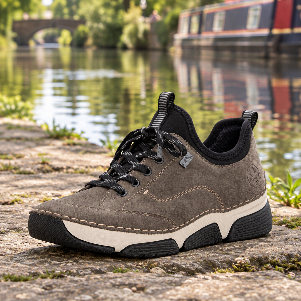 Women's grey suede slip-on sneaker front view with black laces and contrast midsole