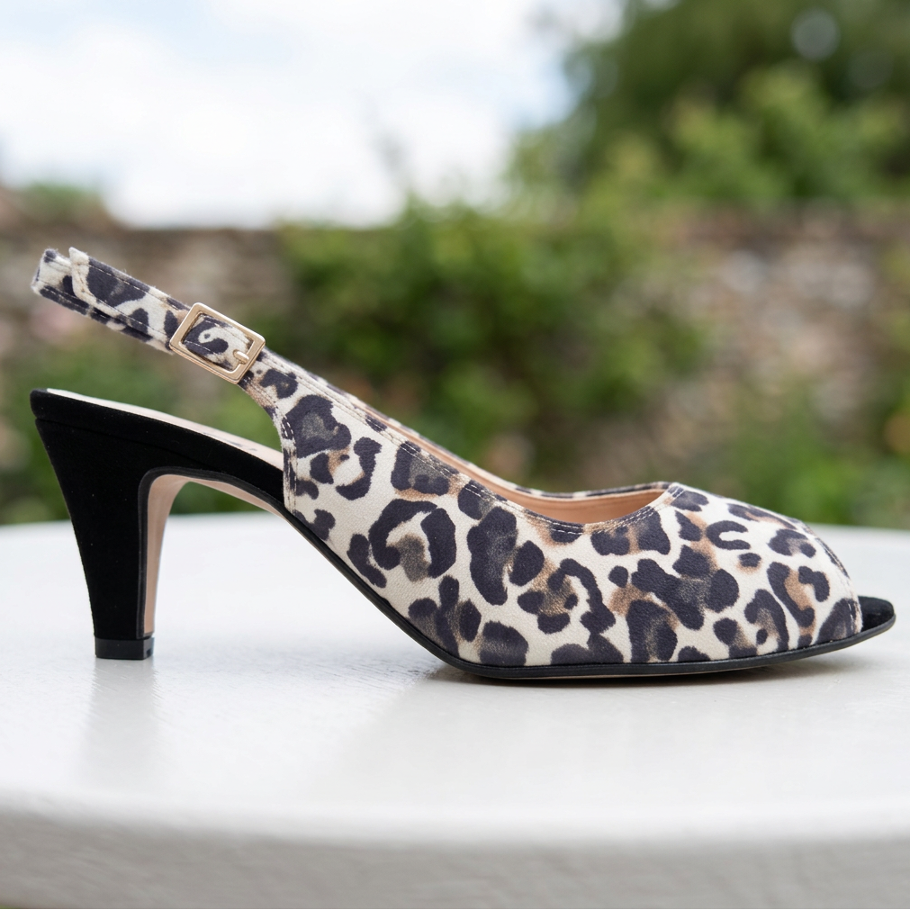 Women's leopard-print beige slingback sandal with mid heel and buckle strap, side view