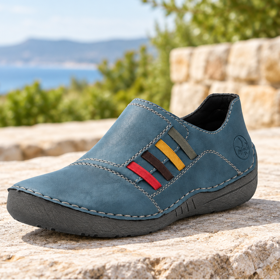 Blue slip-on shoes with colorful stripe trim, contrast stitching, and rubber sole
