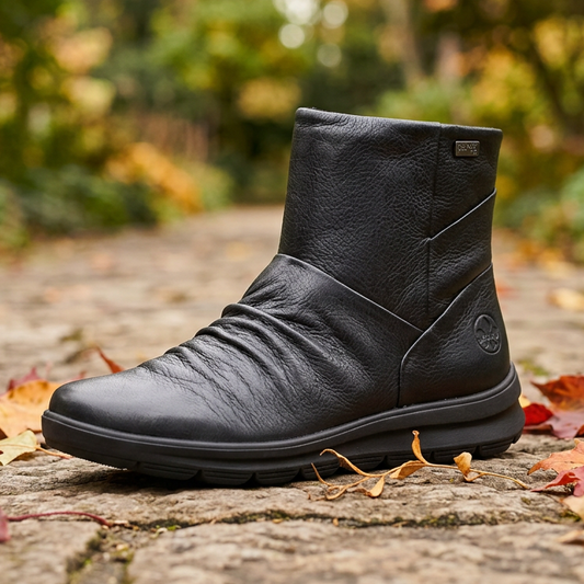 Rieker women's black leather ankle boot with stitched panels and pull-on collar