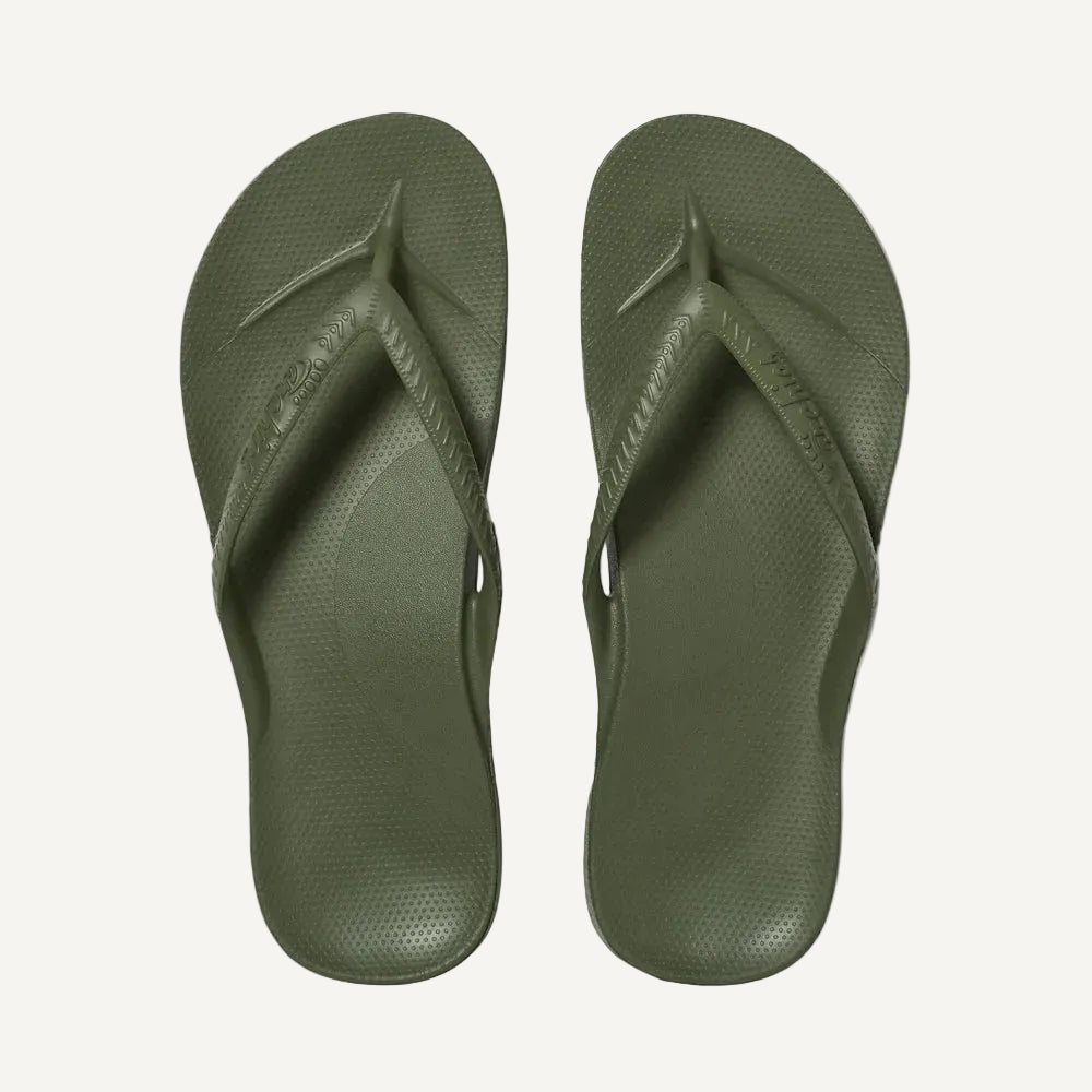 Pair of green flip-flops on a white background