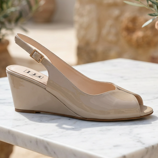 Beige patent wedge sandal with peep toe, ankle strap, and tan wedge heel