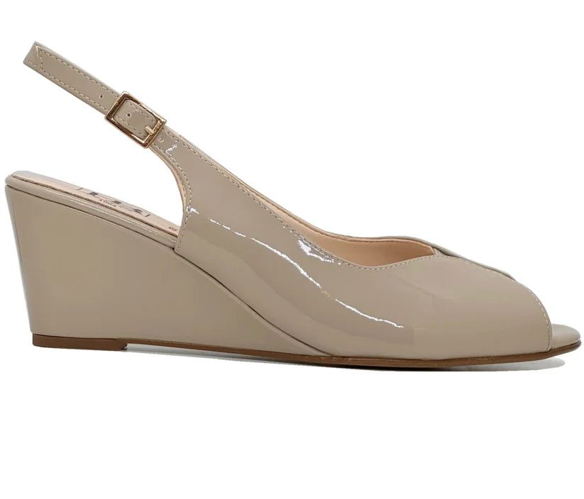 Beige patent wedge sandal with open toe, ankle strap, and low wedge sole