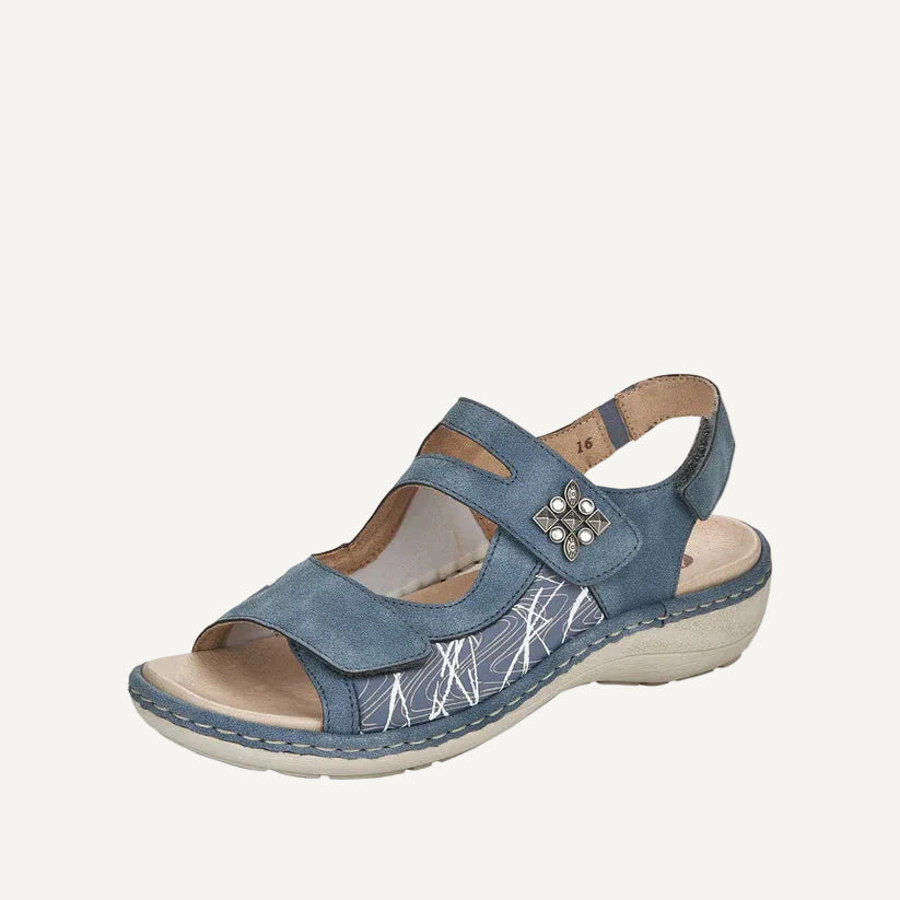 Blue sandal with a decorative buckle on a white background
