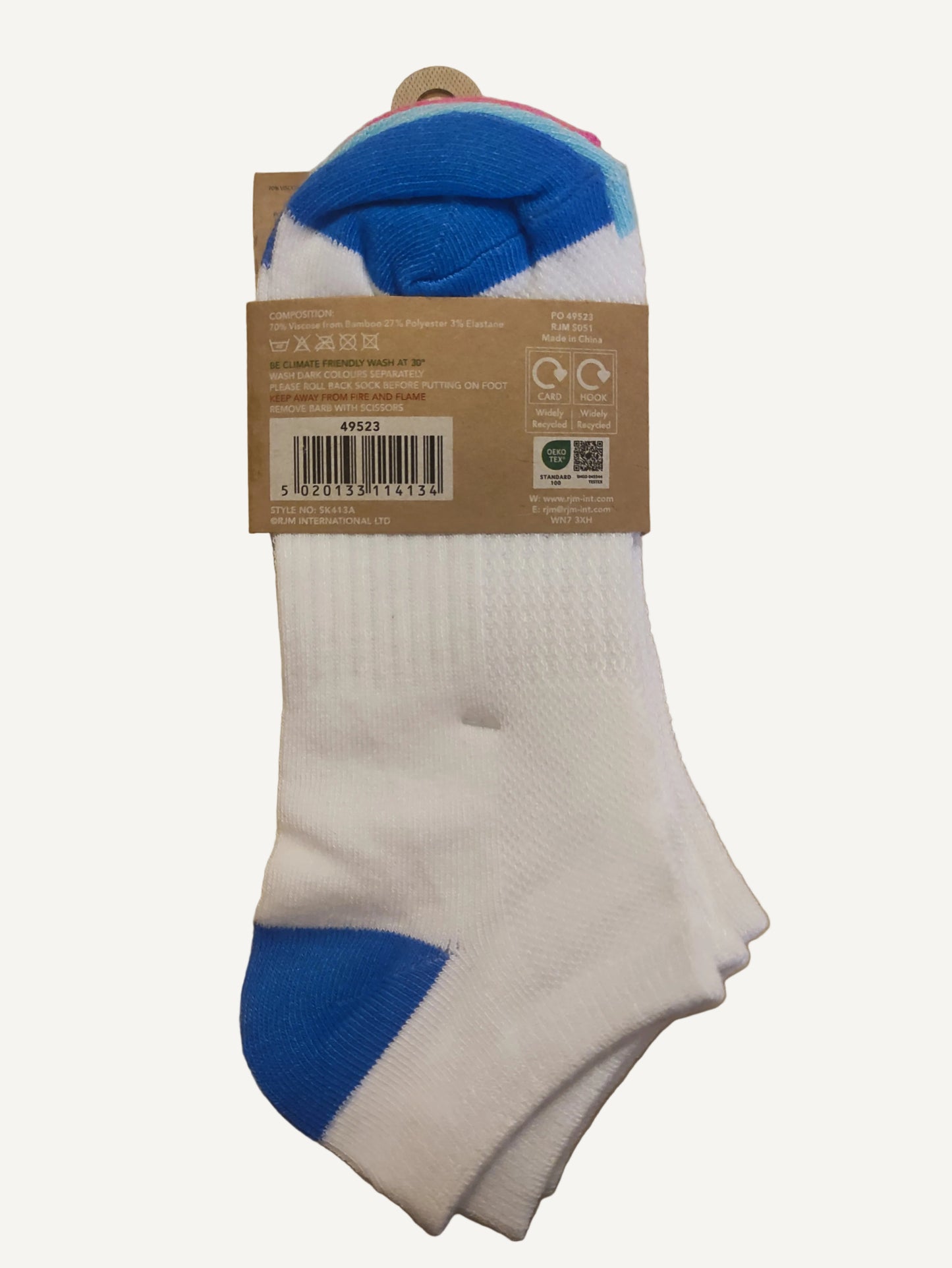 White socks with blue toes and heels on a cardboard label against a wooden surface