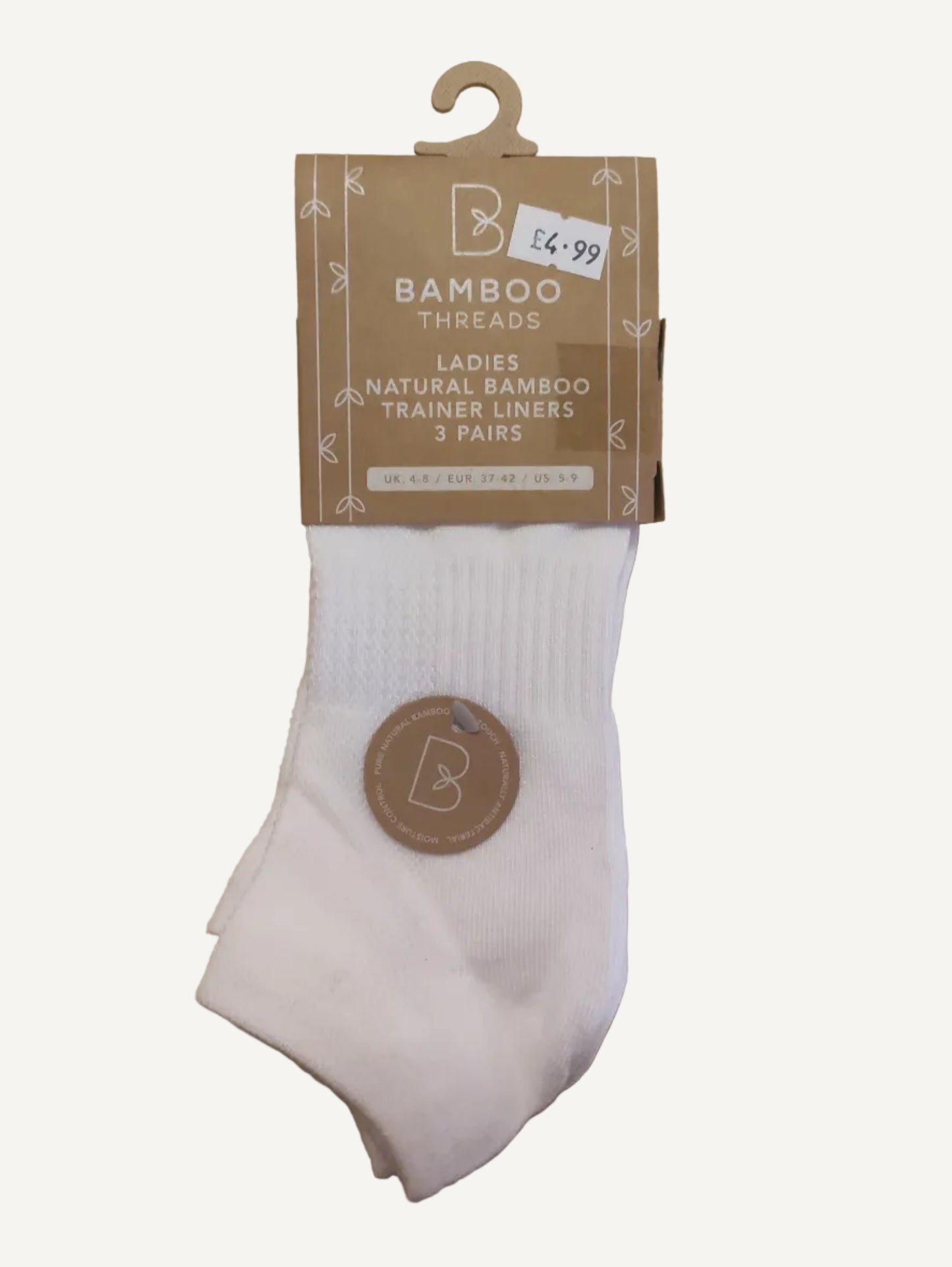White sock with a brown label on a wooden surface