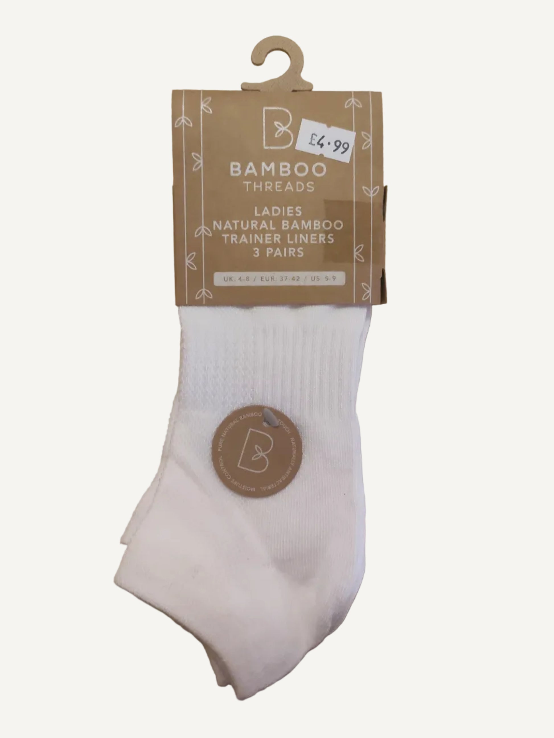 White sock with a brown label on a wooden surface