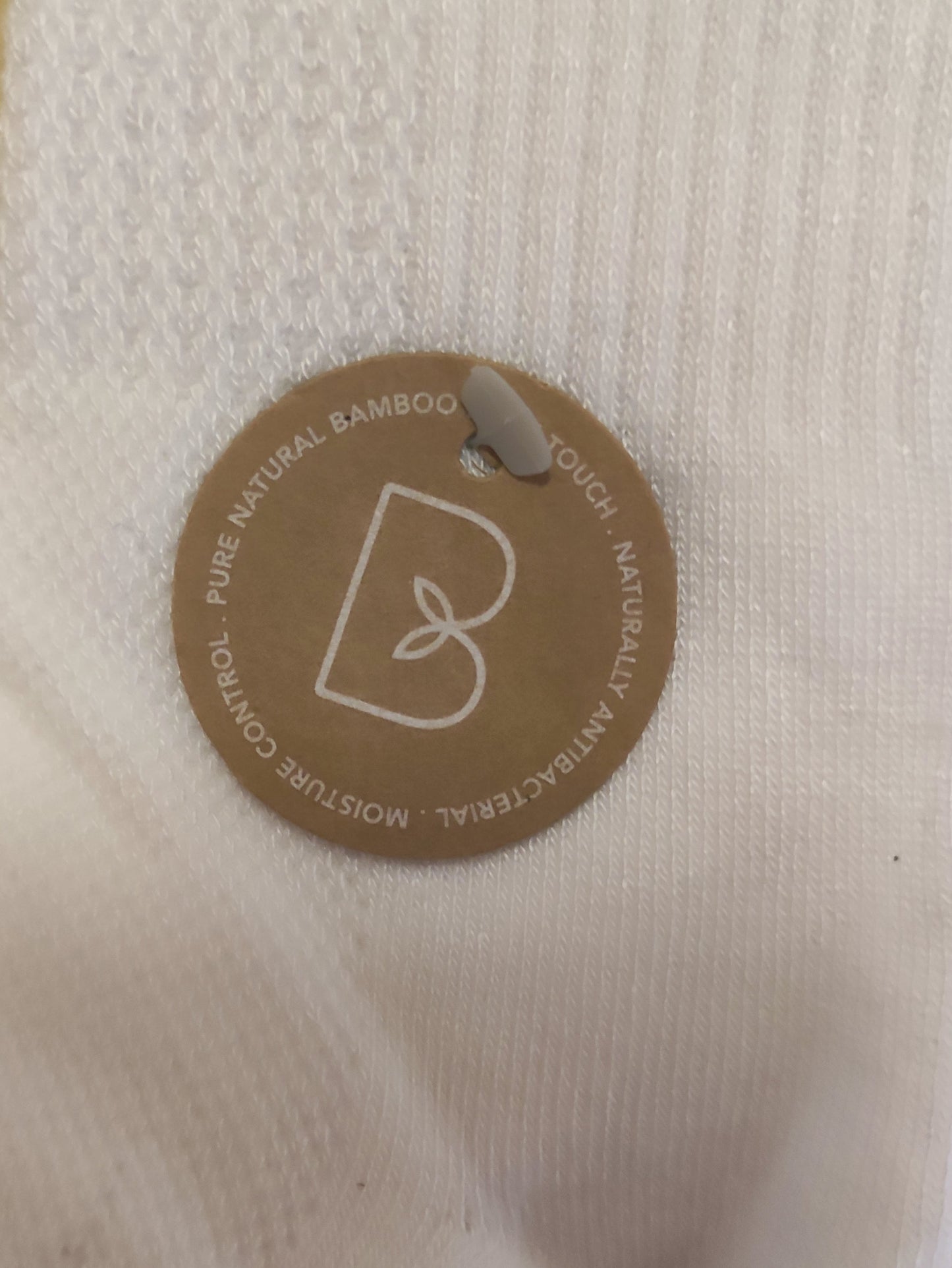 White sock with a brown label on a wooden surface
