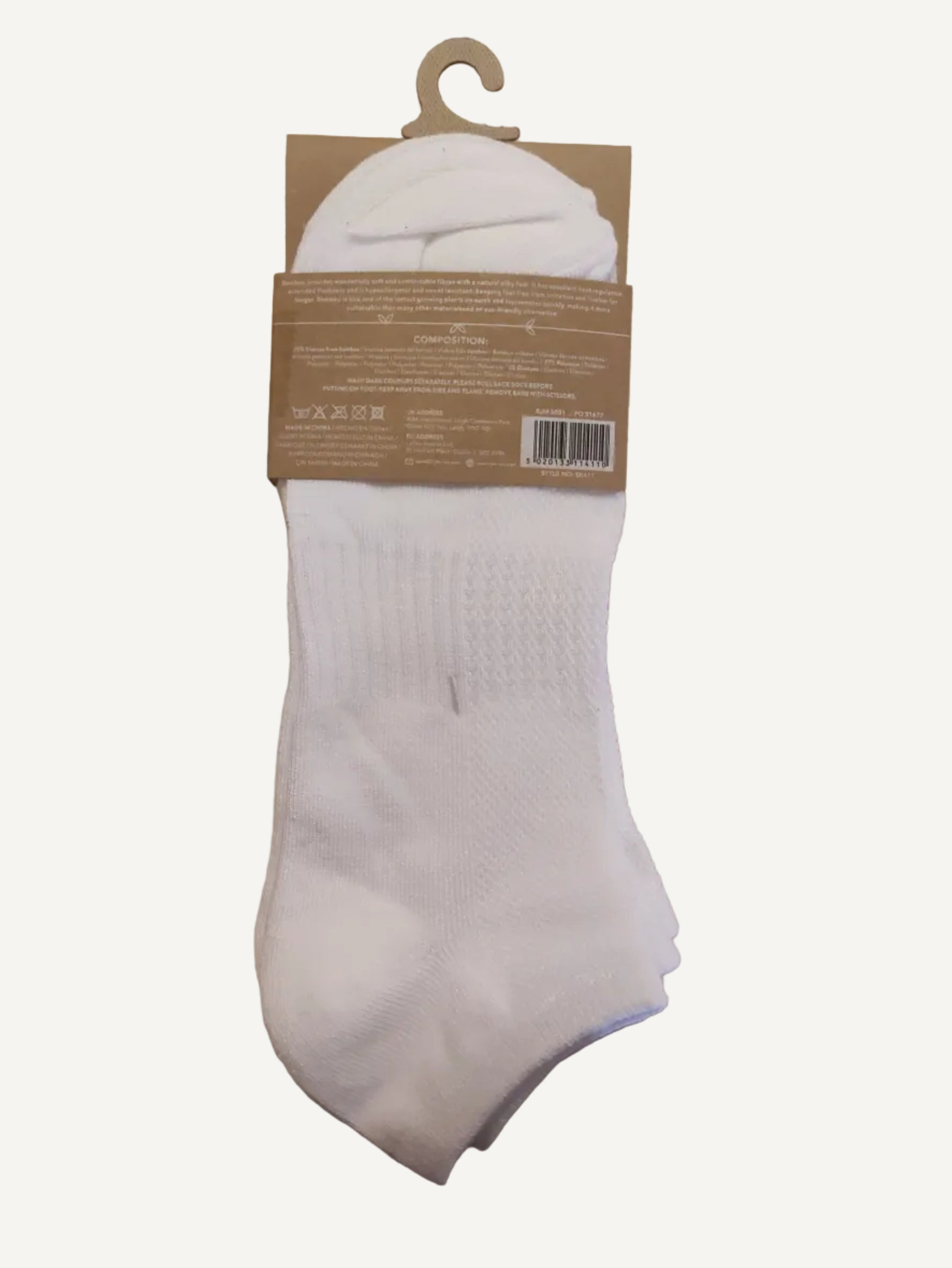 White socks with a brown tag on a wooden surface