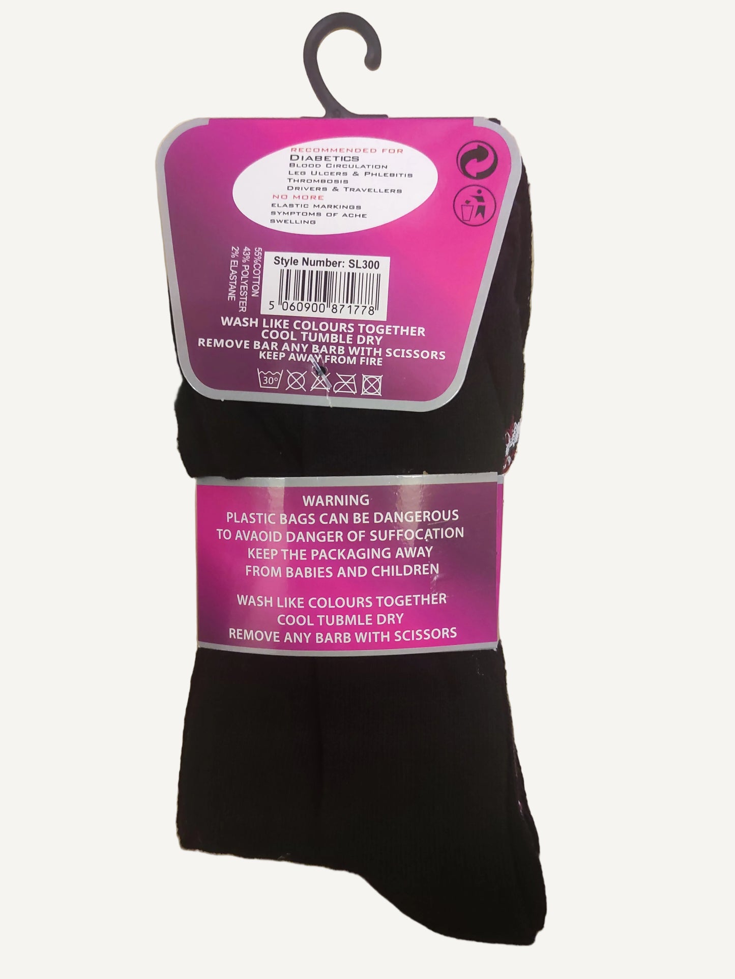 Black socks with pink labels on a wooden surface