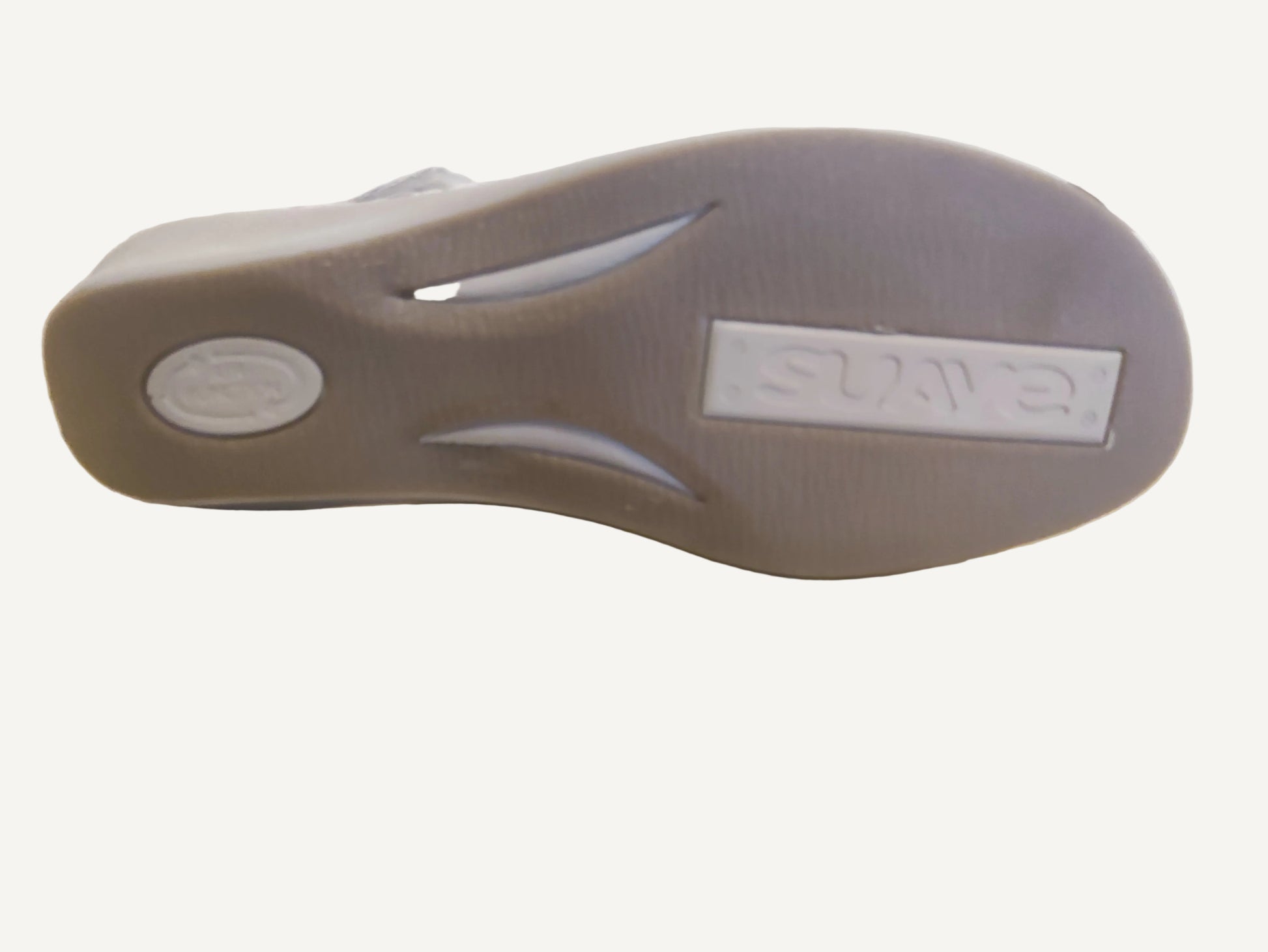 Gray sandal sole with 'GAP' branding on a wooden surface