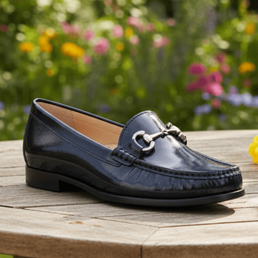 Women’s navy patent loafer angled side view with silver horsebit