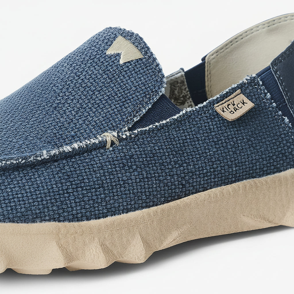 Blue slip-on shoe with beige sole on a white background
