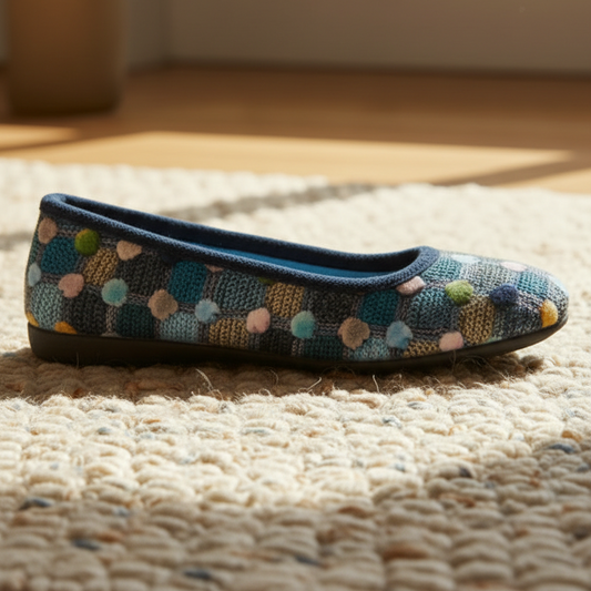 Knitted slipper with colorful pattern on a textured surface