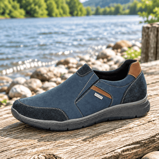 Men's navy waterproof slip-on shoe with stitched upper, tan heel panel, and rubber sole