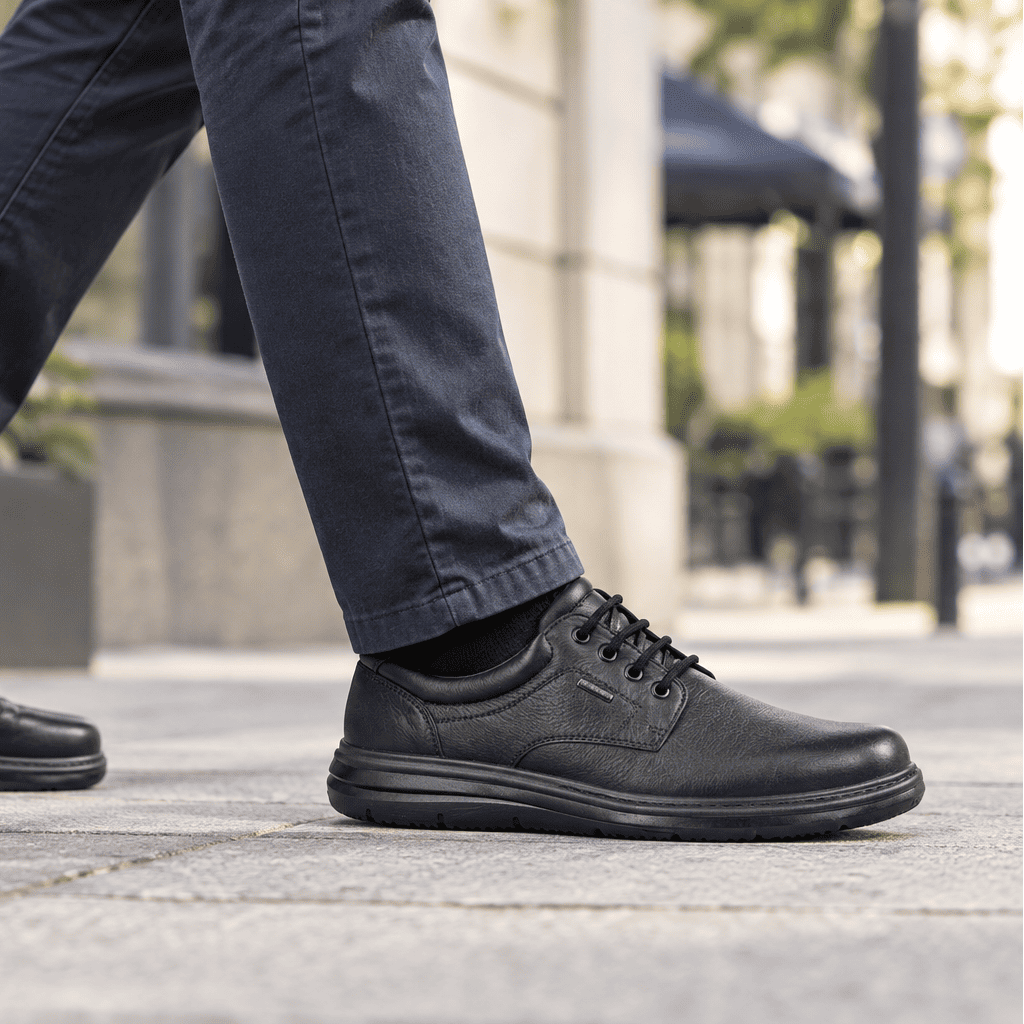 Men's extra-wide waterproof lace-up shoe, black leather, side view with chunky rubber sole