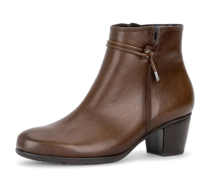 Tan leather ankle boot with side zipper and stitched trim at top