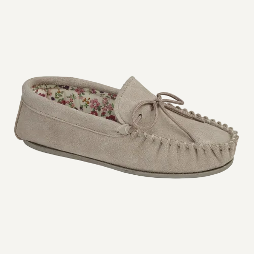 Beige moccasin slipper with floral interior on a white background