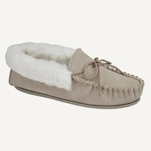 Beige moccasin slipper with white fur lining on a white background