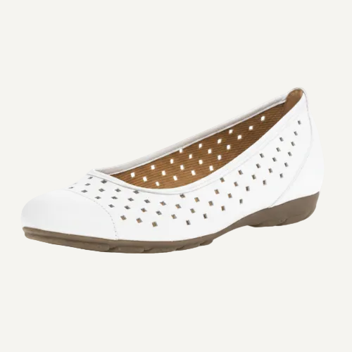 White shoe with brown sole on a white background