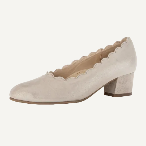 Beige shoe with scalloped edge on a white background