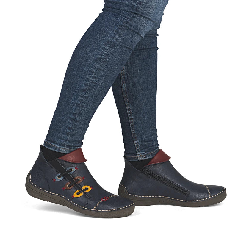 Women’s ankle boots worn with blue jeans; dark blue uppers, brown heel tab, colorful laces