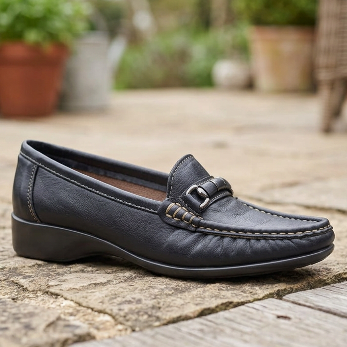 Women's navy leather moccasin with metal buckle strap and stitched moc toe