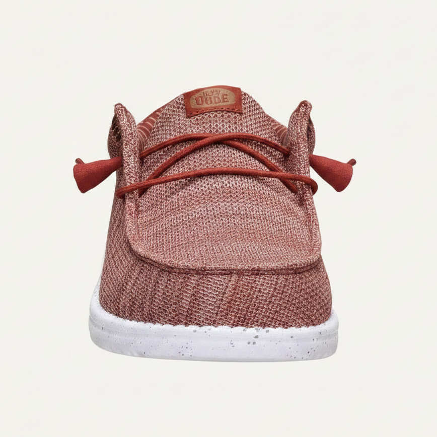 A single knit slip-on shoe shown from the back, featuring a dusty rose pink textured knit upper, matching pink corduroy-style laces with decorative loops, a small tan brand patch reading 'DUFRE', and a speckled white rubber sole.