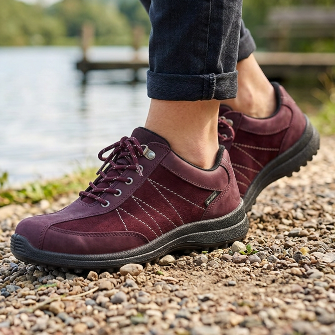 Women's dark cherry lace-up walking shoe worn with jeans and black tread sole