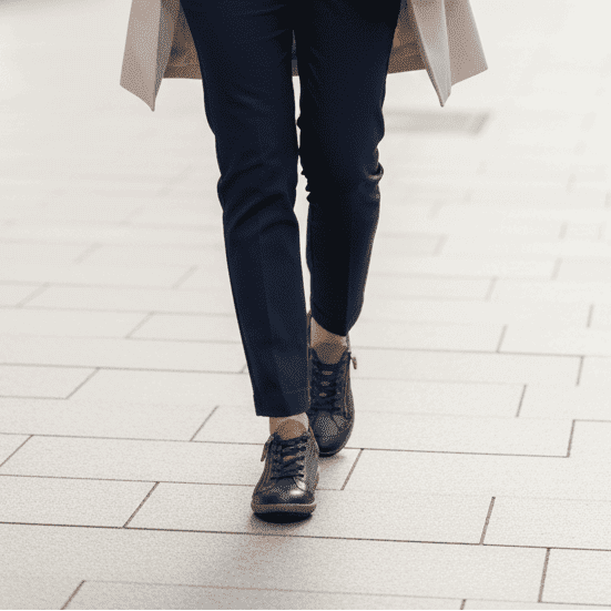 Women’s navy lace-up zip sneakers worn with dark pants and low-profile sole