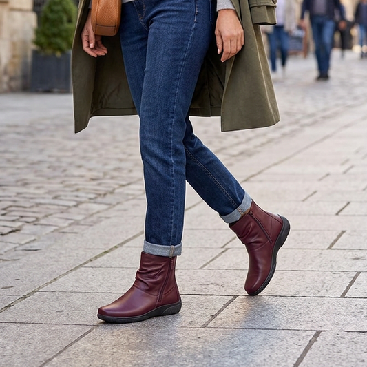 Women's dark cherry leather ankle boots with side zip and chunky sole, worn with jeans